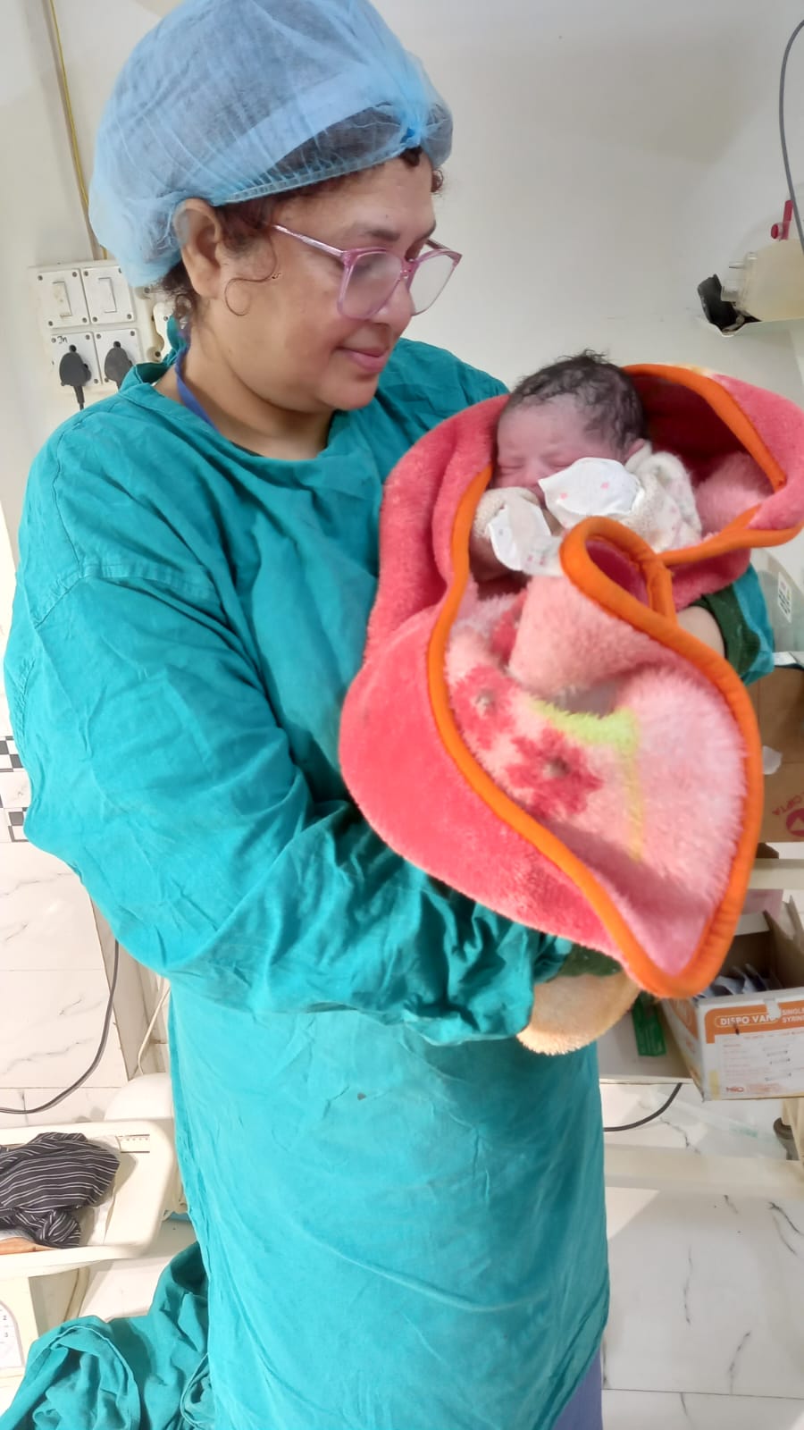 Medical professional with newborn baby after surrogacy