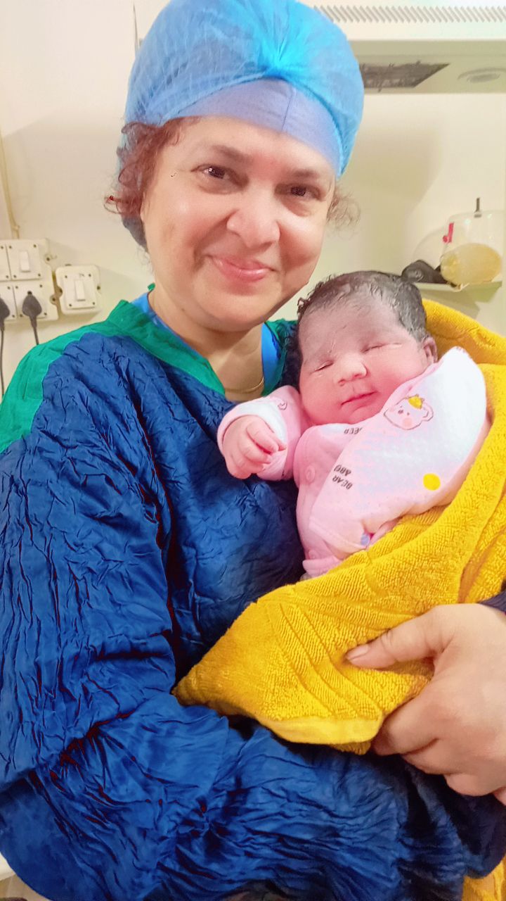 Surrogate mother holding newborn baby